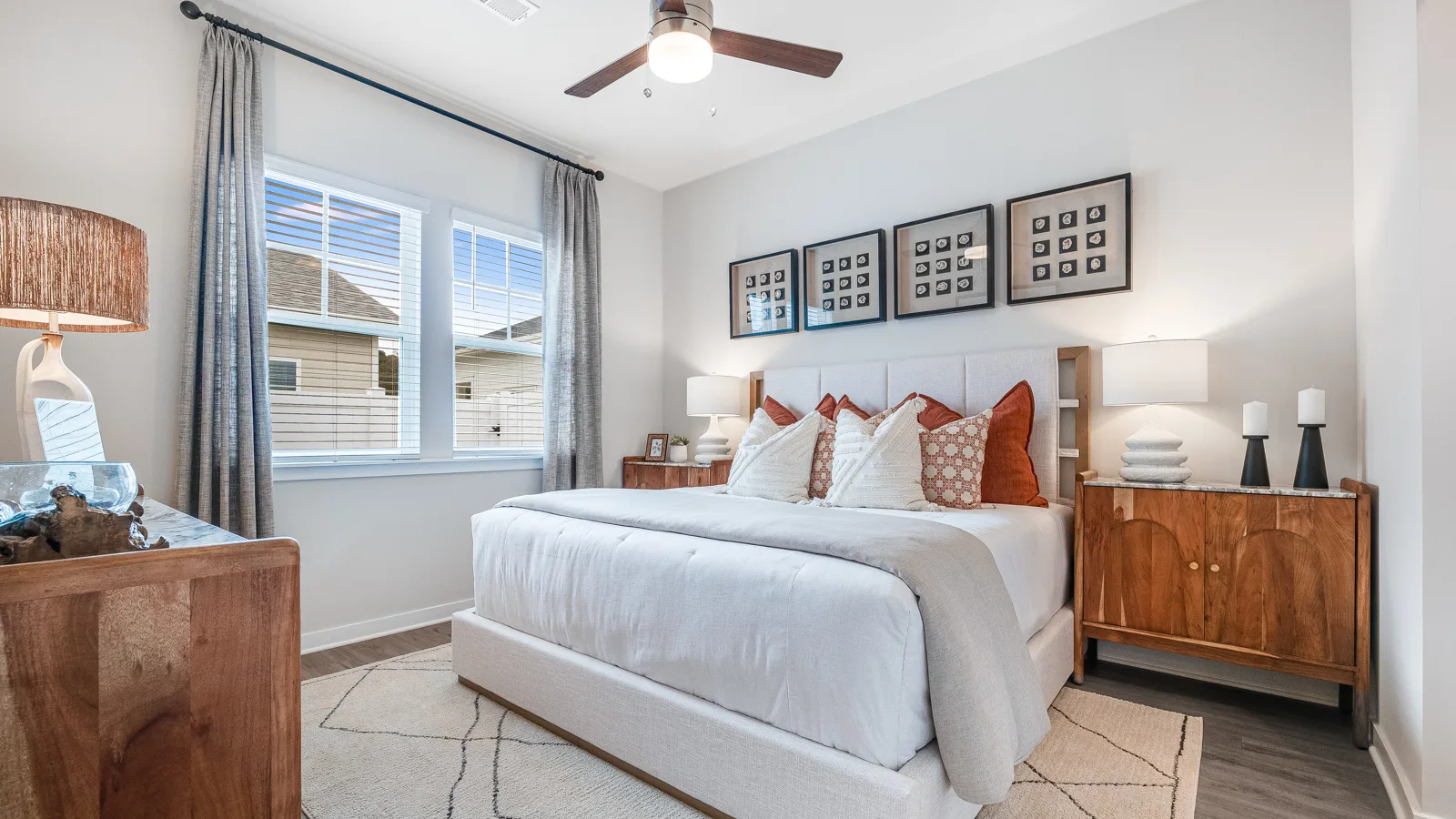 Beautiful bright bedroom with coastal aesthetic and fluffy King bed with a full size dresser and 2 night stands. New pet-friendly apartment homes for rent with private fenced backyards in Monroe, NC, near Charlotte, NC with pool, dog park, gym, and gated community. *No breed or weight restrictions.