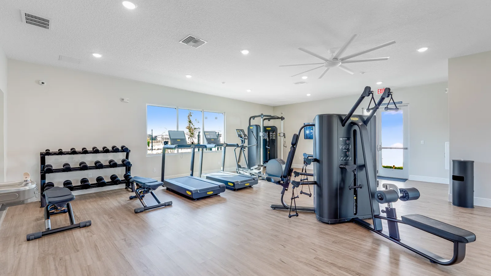 Community apartment gym with stair stepper bike, and rower, as well as lifting equipment and assisted machines. New pet-friendly apartment homes for rent with private fenced backyards in Kissimmee, FL, near Orlando, FL with pickle ball, dog park, gym, and gated community. *No breed or weight restrictions. Yardly Bellalago